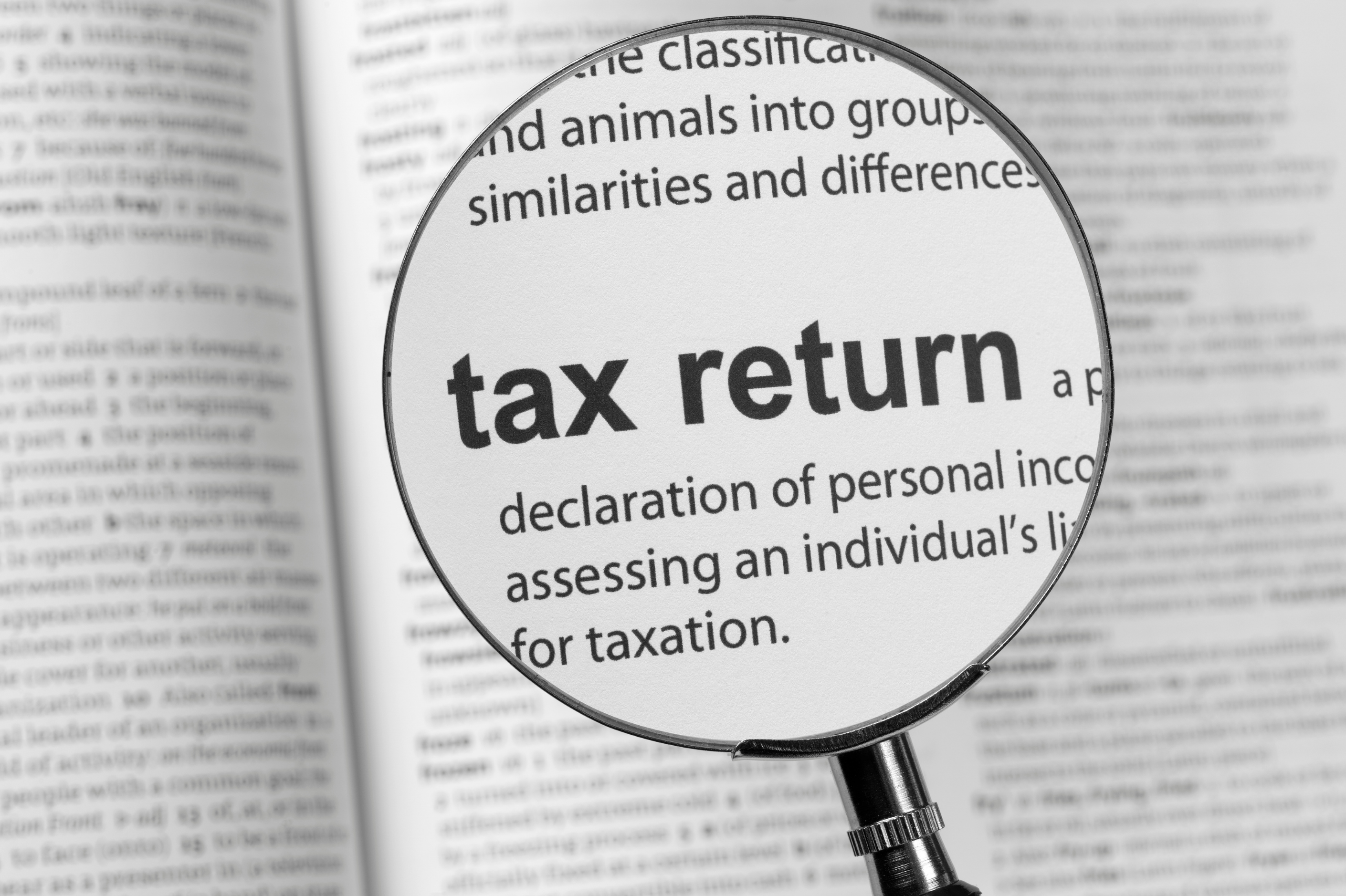 Magnifying glass hovering over a page of text and focusing on